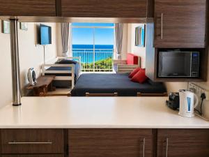a room with a bed and a room with a view at Scottburgh Peacehaven Holiday Flat 202 in Scottburgh