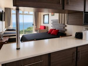 a bedroom with a bed and a view of the ocean at Scottburgh Peacehaven Holiday Flat 202 in Scottburgh