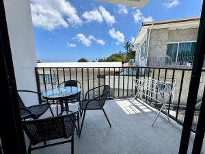 a patio with a table and chairs on a balcony at Buddha View Hostel & Diving in Ko Tao