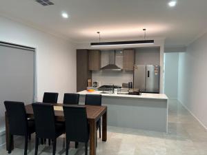 a kitchen and dining room with a table and chairs at Private Room in Rockbank in Rockbank