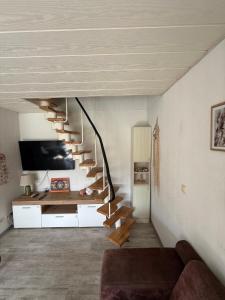 a living room with a spiral staircase in a house at Nordwind Sjut in Warnow