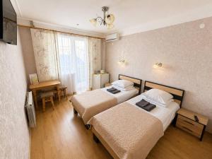 a hotel room with two beds and a window at Hotel Jasmin All Inclusive in Truskavets +23 photos