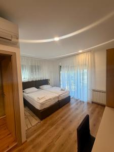 a bedroom with a large bed in a room at Domus Klek in Kučinić-Selo
