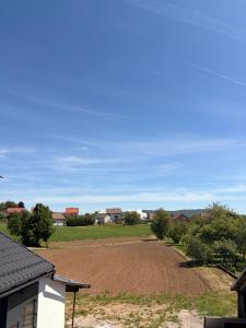 a dirt field with houses in the background at Domus Klek in Kučinić-Selo +2 photos