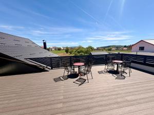 a deck with chairs and tables on a roof at Domus Klek in Kučinić-Selo