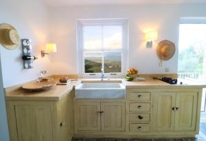 a kitchen with a large sink and a window at Guesthouse Thomas in Vátos +37 photos