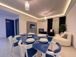 a living room with a blue table and chairs at Seven Floors in Tunis