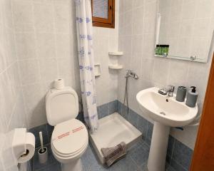a bathroom with a toilet and a sink at Perfect House in Pefkochori