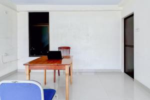 a desk with a laptop on it in a room at Urbanview Hotel MD Residence in Sunggal