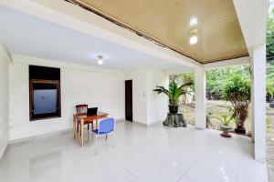 a living room with a table and a laptop on it at Urbanview Hotel MD Residence in Sunggal