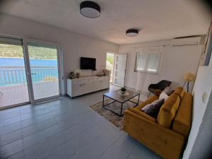 a living room with a couch and a television at Panorama in Drvenik Veli