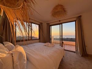 a bedroom with a bed with a view of the ocean at Slow Life in Imsouane