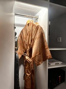 a jacket is hanging on a rack in a closet at Ra Premiere Simatupang in Jakarta +75 photos
