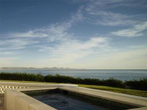 a swimming pool with a view of the water at One&Only Palmilla in San José del Cabo