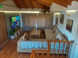 a living room with a couch and a tv at Vista Mare in Nea Irakleia