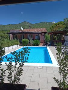 a swimming pool in front of a house at Villa Meja in Hreljin