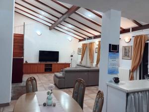 a living room with a couch and a table at Villa Meja in Hreljin