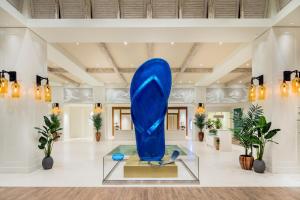 a large blue sculpture in a lobby with plants at Margaritaville Hollywood Beach Resort in Hollywood