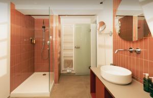 a bathroom with a shower and a sink and a toilet at HOY bamberg boutique hotel in Bamberg +62 photos