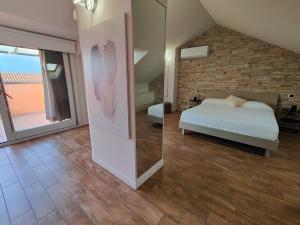 a bedroom with a bed and a brick wall at Riflessi sul lago Lierna bed and breakfast in Lierna