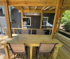 a wooden table and two chairs on a deck at Canvasback Cove on Caddo Lake in Jefferson
