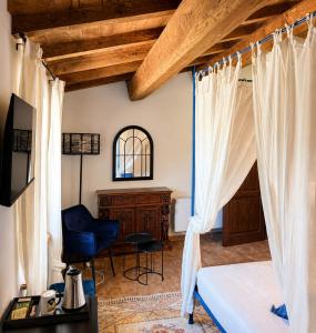 a bedroom with a bed and a desk and a chair at Claustrum di Colforcella in Cascia