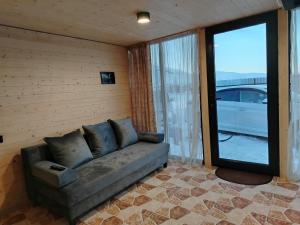 a living room with a couch and a large window at APARAN House in Aparan