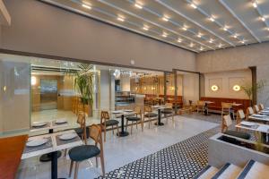 a restaurant with tables and chairs in a room at Mesona Hotels Blue Hill in Antalya +19 photos