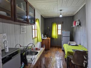 a kitchen with a sink and a refrigerator at Hostel Sao Gabriel - new pool in São Tomé