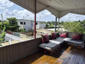 a balcony with a bench on a roof at Hostel Sao Gabriel - new pool in São Tomé