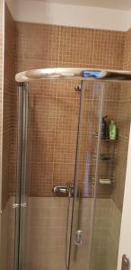 a shower with a glass door in a bathroom at Oasis Resort&Spa Lozenets Studio 12 in Lozenets +9 photos