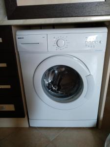 a white washing machine sitting under a counter at Oasis Resort&Spa Lozenets Studio 12 in Lozenets