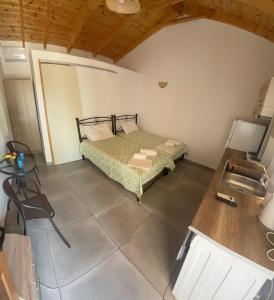 a bedroom with a bed and a desk in a room at Kamares Bay Escape in Gythio