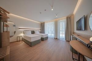 a hotel room with a bed and a television at Aparthotel SamElyon in Samokov