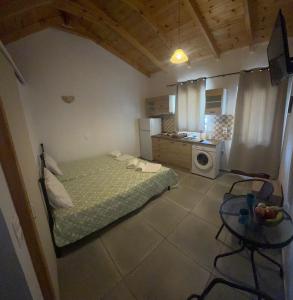 a small room with a bed and a kitchen at Kamares Bay Escape in Gythio +3 photos