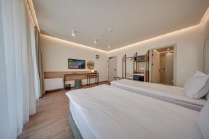 a hotel room with two beds and a desk at Aparthotel SamElyon in Samokov +44 photos