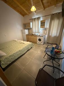 a kitchen with a bed and a table in a room at Kamares Bay Escape in Gythio