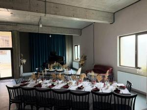 a room with a long table with black chairs at Park Side Hotel Tsalka in Tsalka