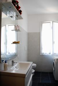 a white bathroom with a sink and a toilet at Da Rina in Mestre