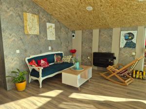 a living room with a couch and a fire place at Lukas cottage in sagarejo in Sagarejo