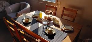 a table with food and drinks on top of it at Sea & Sun Ikaria in Gialiskari