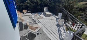 a deck with chairs and a table on a balcony at Sea & Sun Ikaria in Gialiskari +16 photos