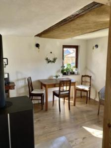 a dining room with a wooden table and chairs at Haus Engelbert in Höchheim