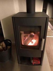 a black stove with a fire inside of it at Haus Engelbert in Höchheim