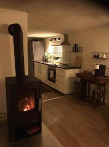a kitchen with a stove in the middle of a room at Haus Engelbert in Höchheim