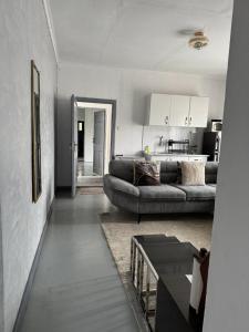 a living room with a couch and a kitchen at Platinum House in Nyeri