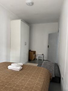 a bedroom with two beds with white cabinets and a bedspread at Platinum House in Nyeri