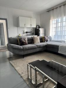 a living room with a couch and a table at Platinum House in Nyeri