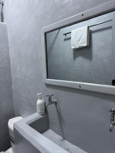 a bathroom with a sink and a mirror at Platinum House in Nyeri