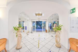 a hallway with two vases with plants in it at Hotel Terme Felix in Ischia Town +73 photos